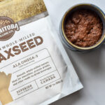 Photo of Chocolate Flaxseed Cake in a mug with a bag of Manitoba Milling Smooth Whole Milled Flaxseed