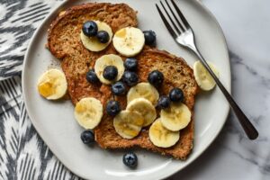 vegan french toast made with Manitoba Milling Smooth Whole Milled Flaxseed topped with blueberries and bananas