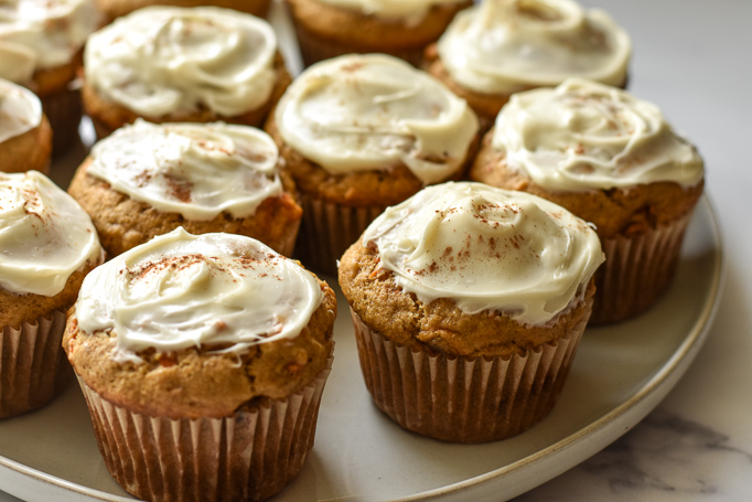 carrot cake flaxseed cupcakes made with crystallized ginger and topped with cream cheese frosting and cinnamon
