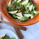 bowl of a delicious holiday salad with a creamy balsamic vinegar dressing