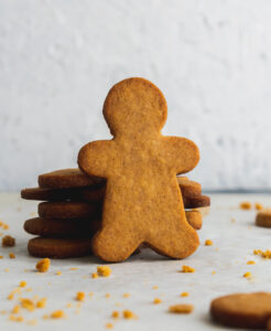 holiday gingerbread man cut out leaning against other gingerbread men
