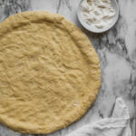photo of pizza dough on marble backdrop